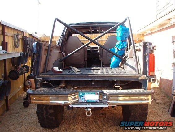 1994 Ford Bronco rear view showing interior, roll cage, and aftermarket bumper