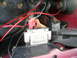 1995 Ford Crown Victoria - Close-up of an engine control module and wiring harness, showing various colored wires and connectors.