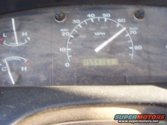 Dashboard gauges showing speed, fuel, and temperature. Odometer reads 159463