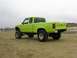 1986 Ford Ranger - This lifted 1986 Ford Ranger pickup truck is shown from the rear 3/4 view on a sandy beach.