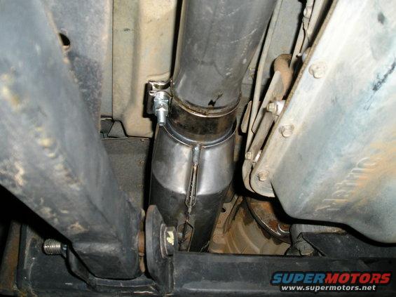 Exhaust pipe and catalytic converter assembly attached to vehicle undercarriage