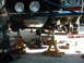 1978 Ford Bronco - Front suspension work on a 1978 Ford Bronco, showing the vehicle supported by jack stands.