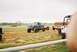 1989 Ford F-350 - Several heavily modified trucks are gathered on a dirt track under an overcast sky.