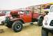 1989 Ford F-350 - A classic red Dodge Power Wagon is displayed with its hood up, its engine and large off-road tires.