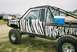 1989 Ford F-350 - This modified pickup truck features a distinctive zebra paint job and a protective roll cage.