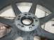 1996 Ford Probe - A close-up view of a black alloy wheel, focusing on the central hub and the design of its spokes.