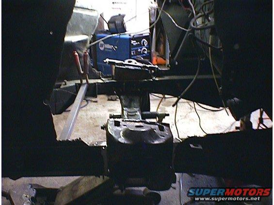 Car interior with welding equipment and metal framing visible