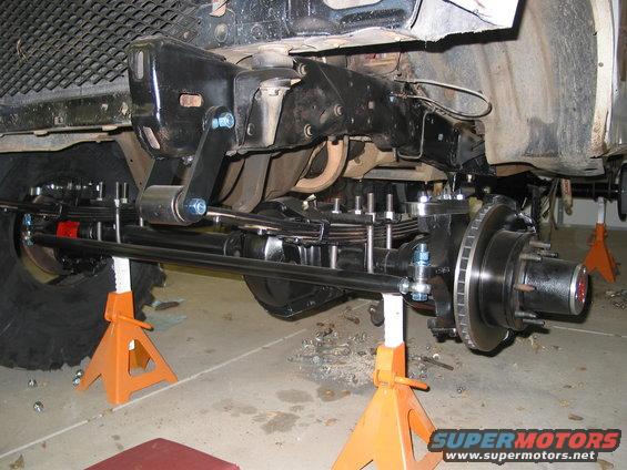 Front axle, leaf springs, and steering linkage on jack stands