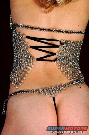 Chainmail corset laced with black ribbon, worn with a matching g-string. Supermotors.net logo visible