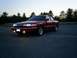 1995 Ford Crown Victoria - A maroon 1995 Ford Crown Victoria is parked in an empty lot as the sun sets.