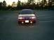 1995 Ford Crown Victoria - A red 1995 Ford Crown Victoria is shown from the front in a parking lot at dusk.