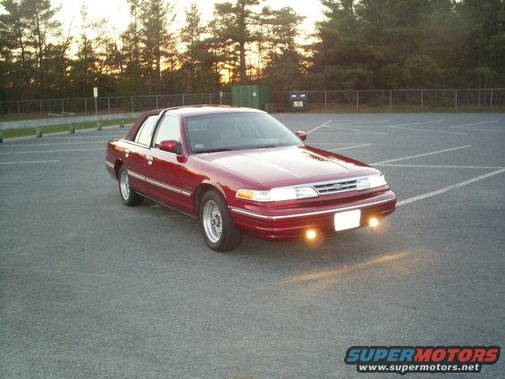 Red 1995 Ford Crown Victoria parked in a lot