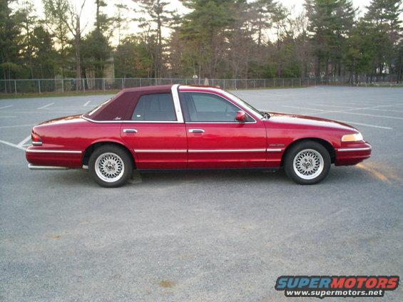 1995 Ford Crown Victoria sedan, red with maroon vinyl top, side view