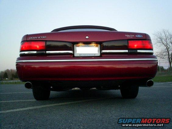 Red 1995 Ford Crown Victoria rear view with license plate frame reading 'Valley Ford'