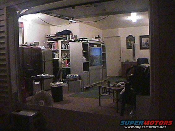 Interior room scene with shelves, TV, and furniture