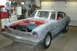 1981 Ford Mustang - A 1970 Ford Maverick coupe is undergoing restoration in a garage, showing its engine and red interior.