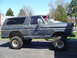 1979 Ford Bronco - This 1979 Ford Bronco is a lifted SUV with significant body damage visible on its side panels.