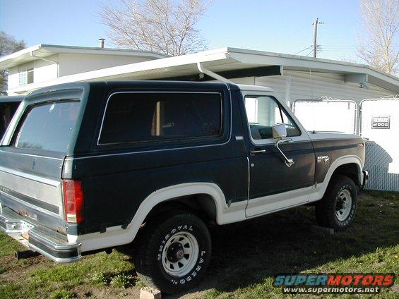 1981 Ford Bronco parked in front of a house, side view