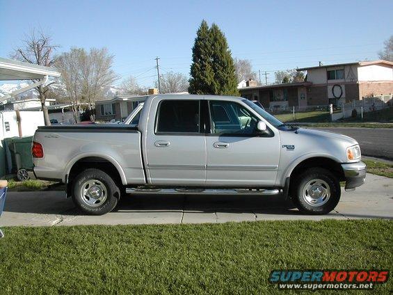 Silver four-door pickup truck parked on a driveway