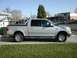1981 Ford Bronco - This pickup truck has a crew cab and a long bed, parked in a suburban setting.
