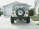 1995 Jeep Wrangler - This 1995 Jeep Wrangler is seen from the rear, its iconic spare tire mount and soft top.