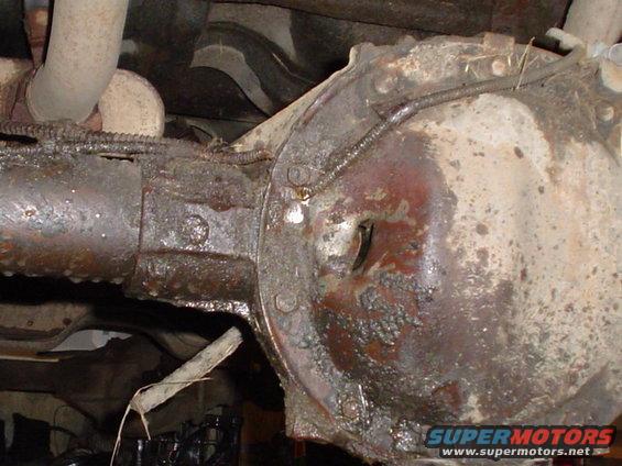 Rusty rear differential and exhaust pipe under a vehicle