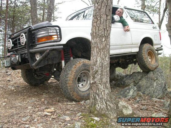 White 1990 Ford Bronco navigating rocky terrain