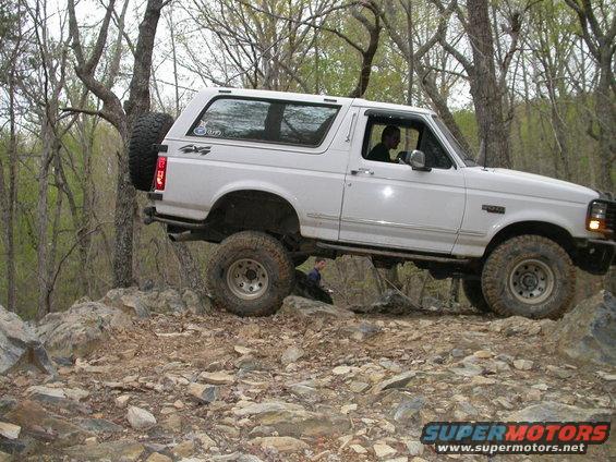 White 1990 Ford Bronco navigating rocky terrain