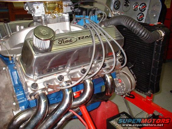 Ford Racing engine with chrome valve covers, headers, and a Holley carburetor