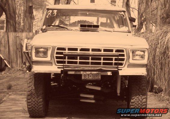 Front view of a lifted 1978 Ford Bronco with a hood scoop and off-road tires