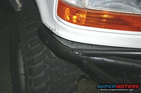 1995 Ford Bronco front corner showing tire and aftermarket tubular bumper