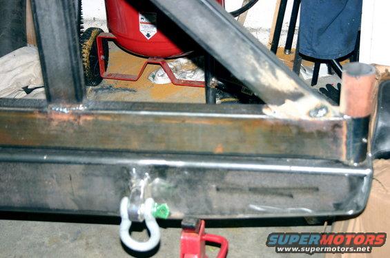 Custom metal rear bumper with tow hitch and shackle mount, showing welds and unfinished metal