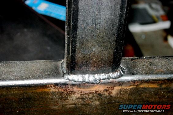 Close-up of a welded metal joint on a frame, possibly part of a custom bumper or carrier