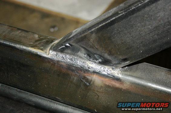 Welded metal frame with visible weld beads and some surface wear