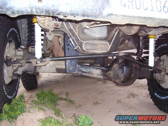 Undercarriage of a 1994 Ford Bronco showing lift kit components, front axle, and suspension