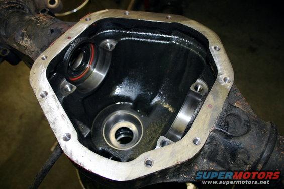 Differential housing with bearing races installed, showing a clean gasket surface