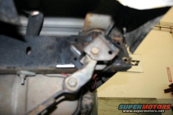Close-up of a vehicle's suspension linkage and frame components
