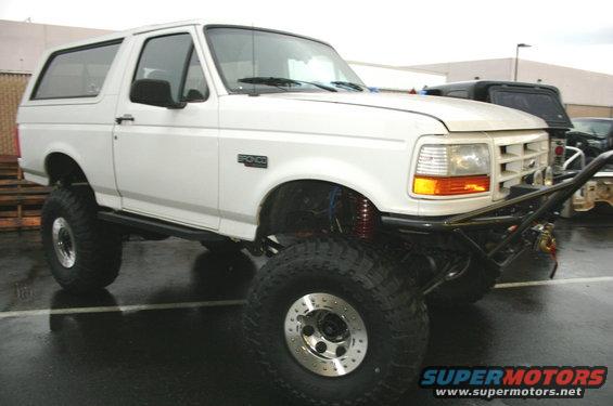 White 1995 Ford Bronco with custom front bumper and large tires
