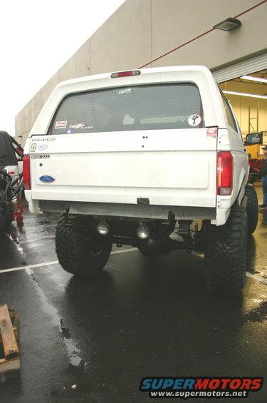 1995 Ford Bronco rear view, lifted with large off-road tires and dual exhaust