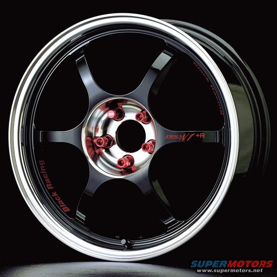 Black racing wheel with red lug nuts and silver lip