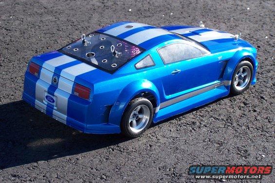 Blue RC car with silver stripes, rear view. Ford logo on back