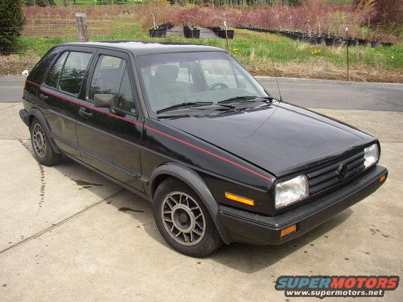 Black 1987 Volkswagen Golf hatchback parked on concrete