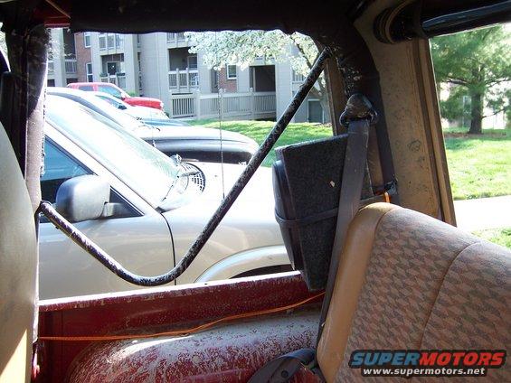 Interior view of a Jeep looking out at other vehicles parked outside