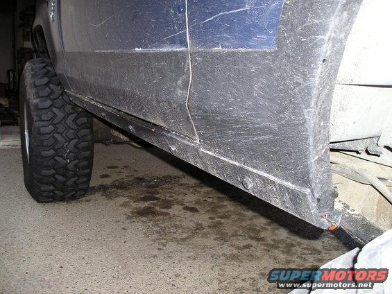 Blue vehicle side panel and large off-road tire