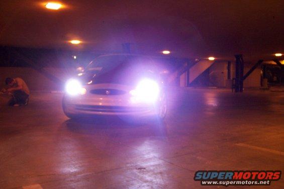 1998 Mercury Sable with headlights on in a parking garage