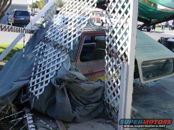 1979 Ford Bronco side view, partially covered by tarp and lattice
