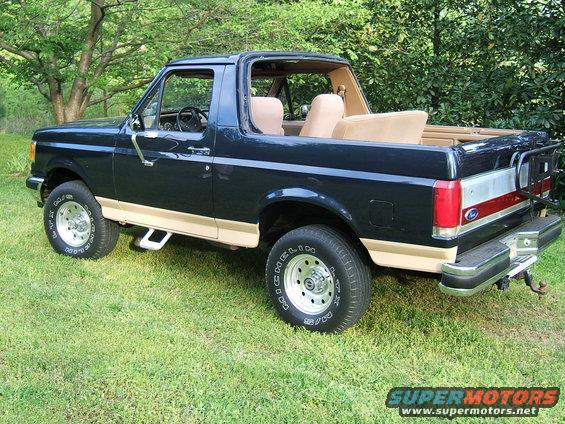 1988 Ford Bronco with removable top, dark blue exterior, tan lower trim, and tan interior