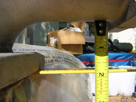 Yellow Stanley measuring tape against a metallic surface and cardboard boxes
