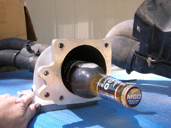 Intake manifold with Miller Genuine Draft bottle inside. Part is silver