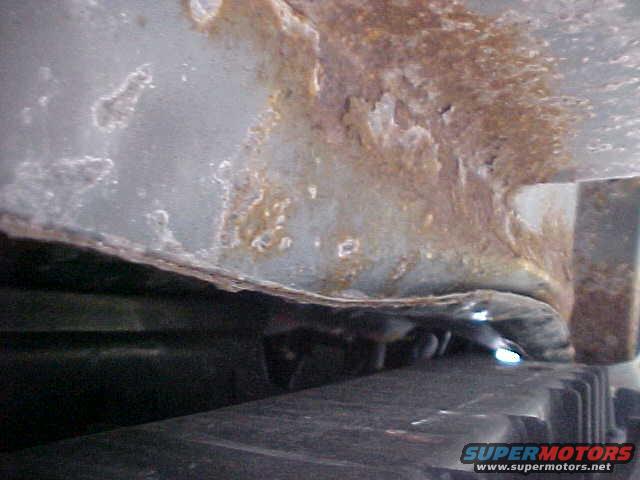 underneath car looking towards the driver side of the car